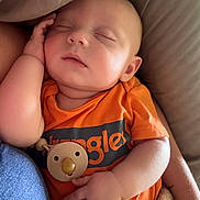 Waylon joined the competition — help win amazing prizes! baby, sleeping, orange_shirt, pacifier, blanket, arm, hand, face, infant, cozy, resting, child, cute, comfort, toddler, closeup, indoor, soft_lighting, peaceful, portrait