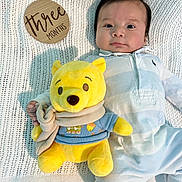 Jayden joined the competition — help win amazing prizes! baby, infant, plush_toy, yellow_bear, knitted_blanket, wooden_sign, three_months, onesie, striped_clothing, scarf, soft_toy, child, portrait, laying_down, cute, indoor, calm, curious, baby_clothes, baby_boy