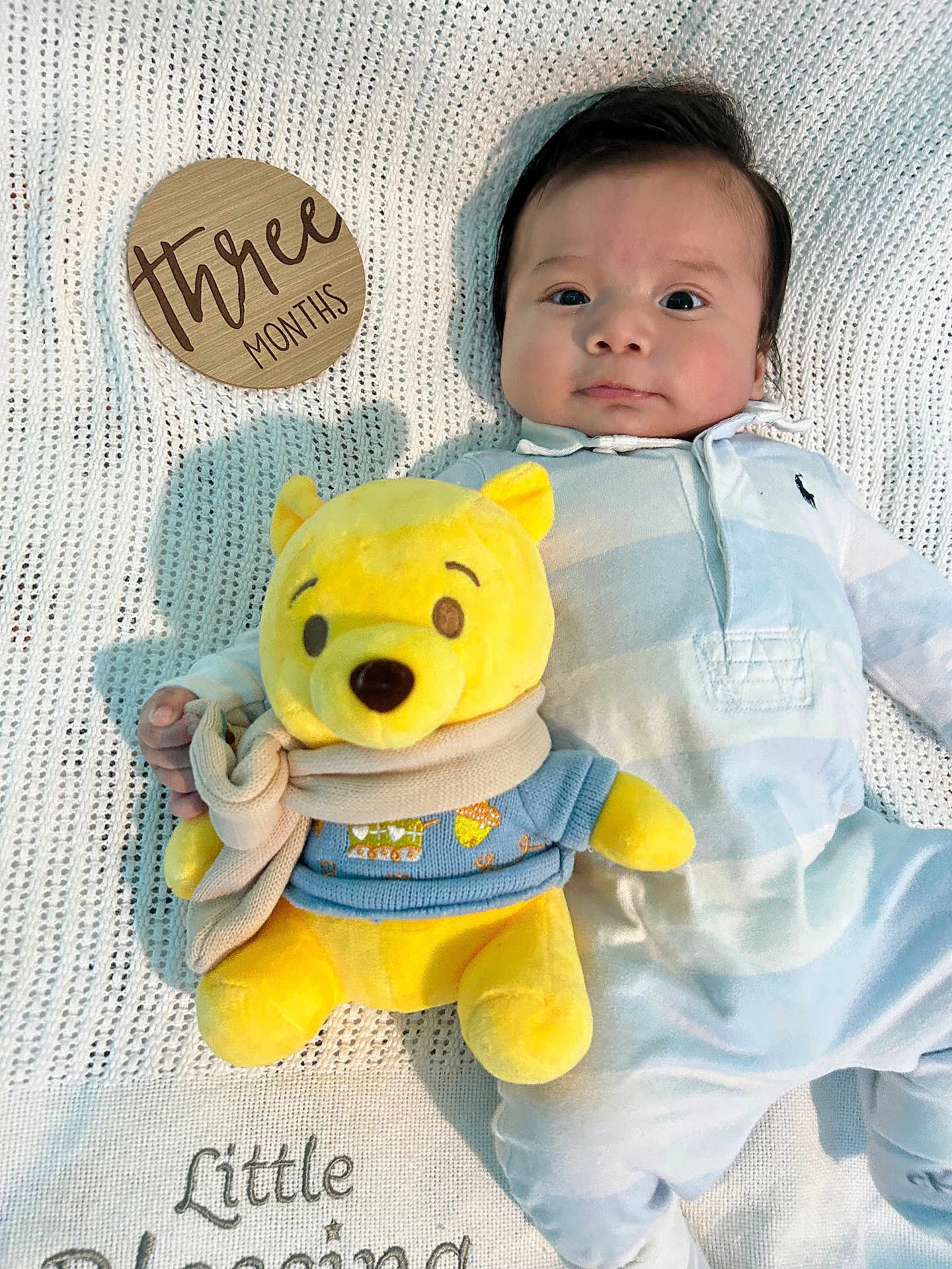Jayden joined the competition — help win amazing prizes! baby, infant, plush_toy, yellow_bear, knitted_blanket, wooden_sign, three_months, onesie, striped_clothing, scarf, soft_toy, child, portrait, laying_down, cute, indoor, calm, curious, baby_clothes, baby_boy