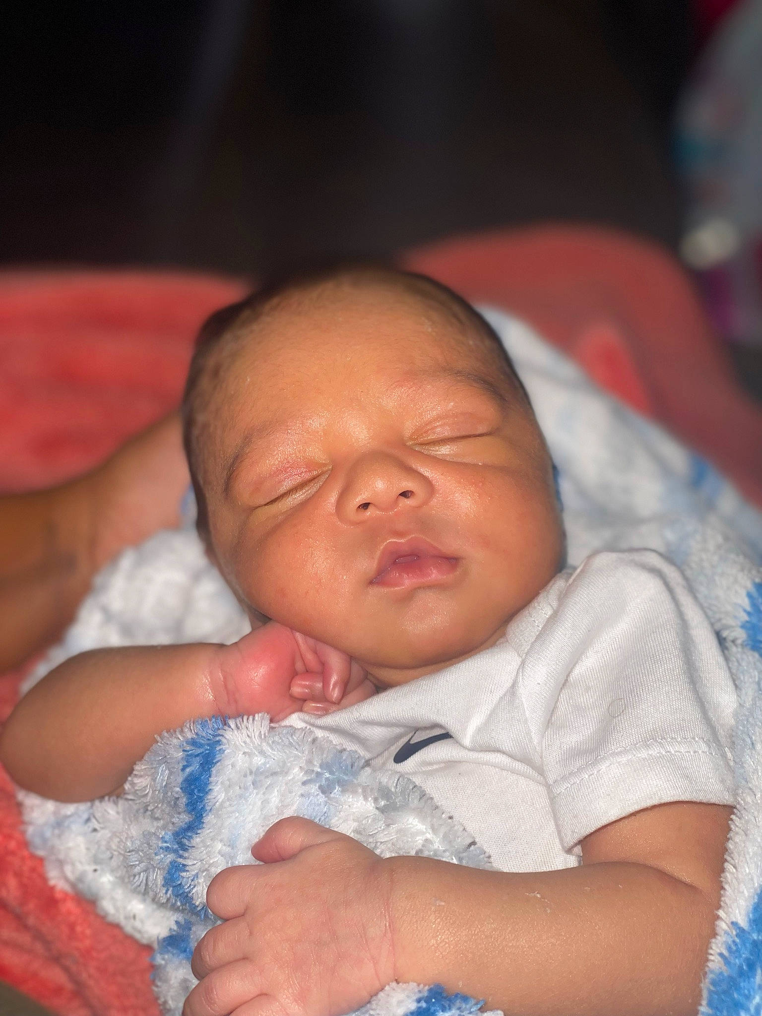 Khai is registered to the contest to win money with this photo: baby, baby_toddler_clothing, cheek, chin, comfort, ear, eye, eyebrow, finger, gesture, hand, iris, lip, mouth, nose, person, product, skin, textile, thumb