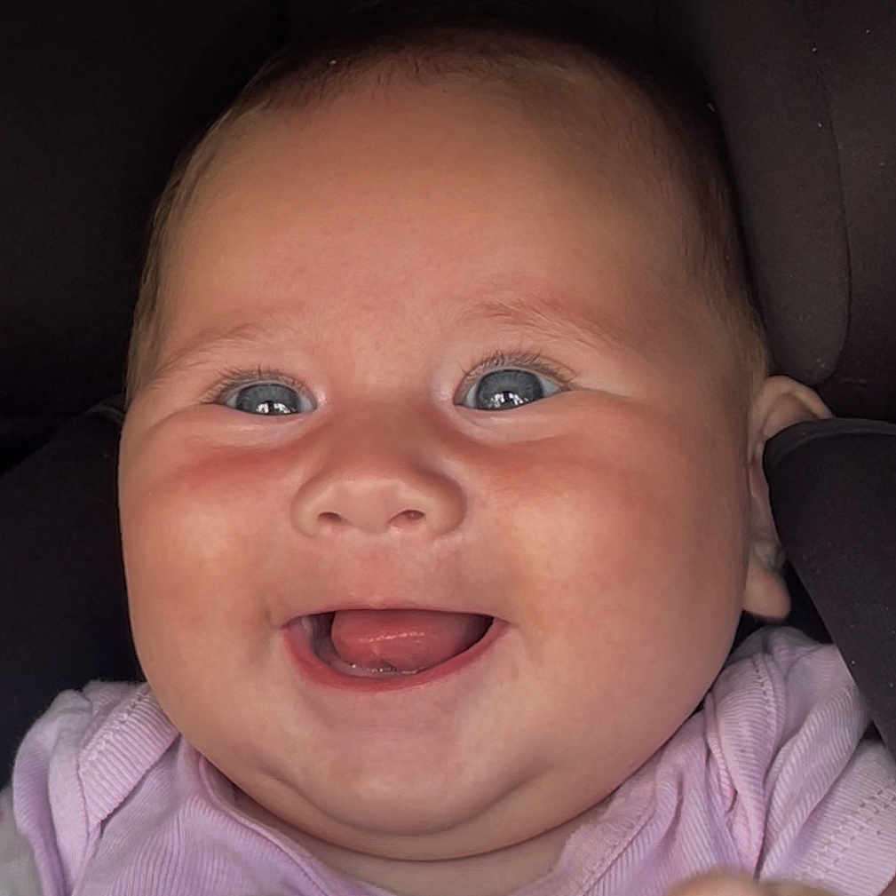 Joy participe au concours pour gagner de l'argent avec cette photo : baby, baby_girl, blue_eyes, child, chubby_cheeks, closeup, cute, expression, face, happy, head, indoors, infant, joyful, person, pink_clothing, portrait, skin, smiling, young_child