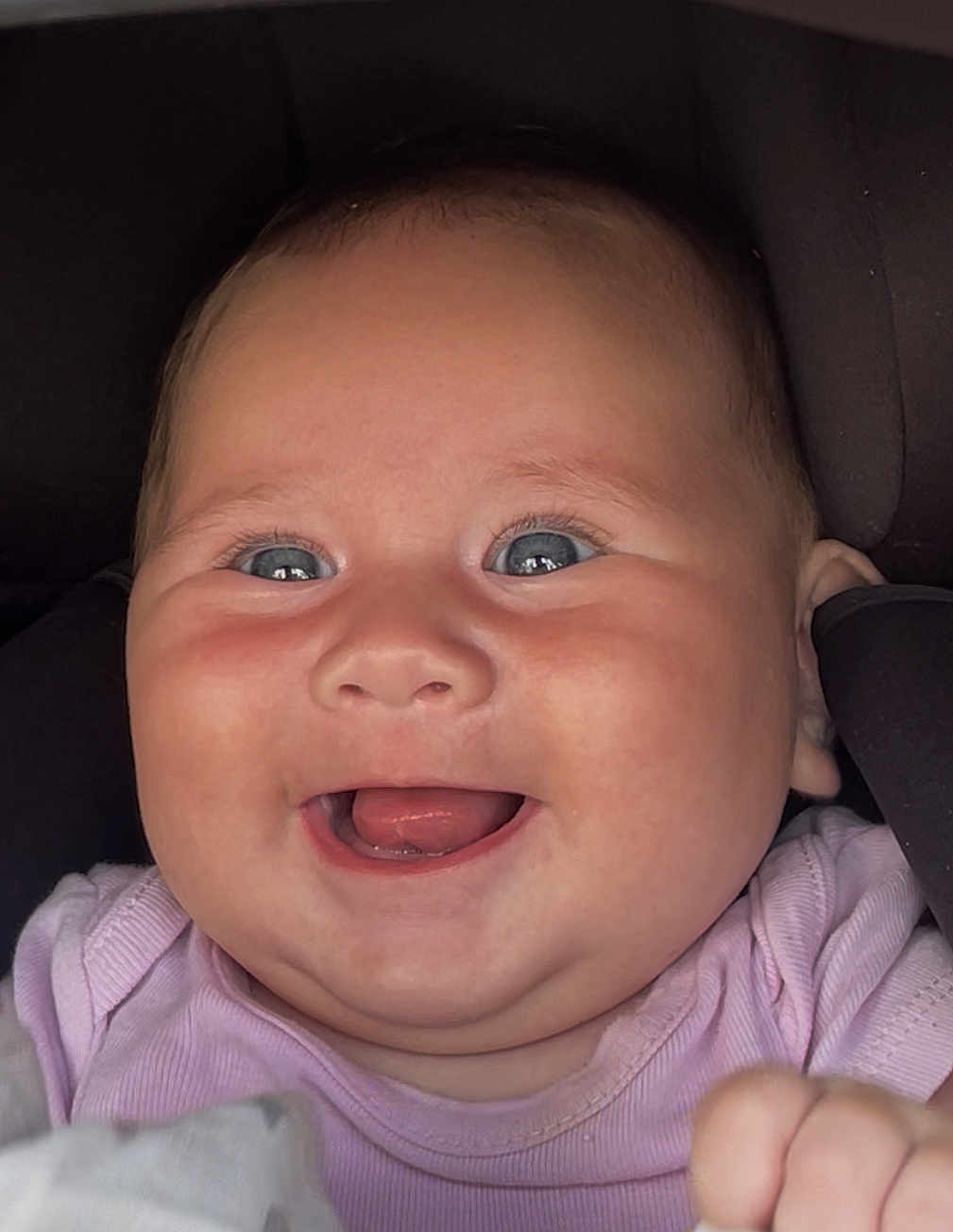 Joy participe au concours pour gagner de l'argent avec cette photo : baby, smiling, face, blue_eyes, pink_clothing, infant, closeup, happy, chubby_cheeks, portrait, child, cute, joyful, person, skin, young_child, indoors, head, expression, baby_girl