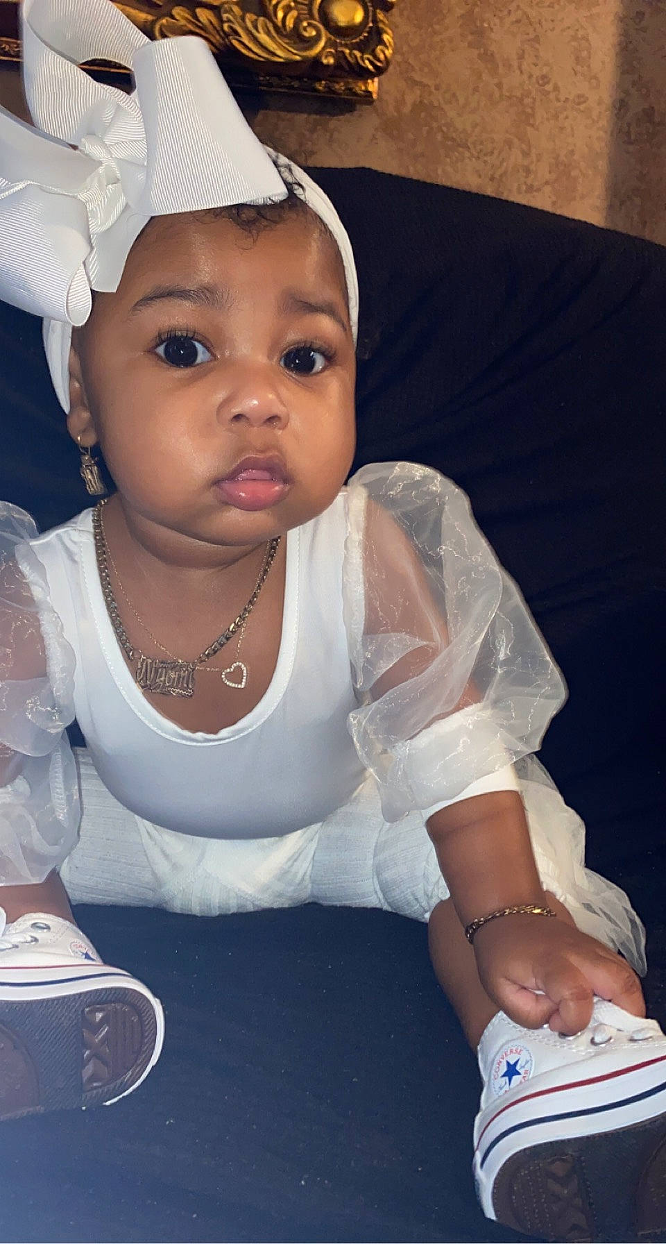 Nyomi is registered to the contest to win money with this photo: arm, baby_toddler_clothing, cheek, dress, eye, eyebrow, eyelash, finger, flash_photography, gesture, hand, happy, headgear, human_body, lip, neck, organ, person, skin, sleeve