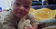Colton joined the competition — help win amazing prizes! baby, baby_clothes, blanket, chair, child, clothing, crawling, door, face, floor, furniture, happy, head, home, indoor, infant, person, room, smile, soft_toy