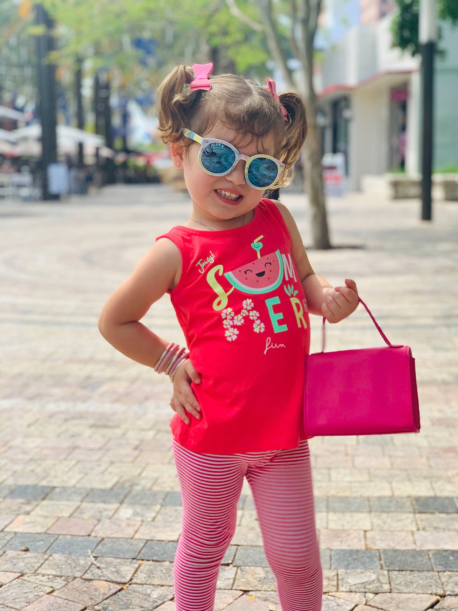 Alejandra is registered to the contest to win money with this photo: baby_toddler_clothing, clothing, eyewear, face, fashion, glasses, goggles, hairstyle, happy, neck, outerwear, person, pink, plant, shoulder, sleeve, street_fashion, sunglasses, t_shirt, vision_care