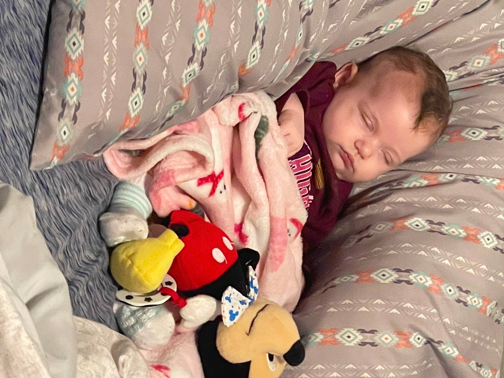 Avery is registered to the contest to win money with this photo: baby, baby_toddler_clothing, bed, bed_sheet, bedding, bedtime, child, comfort, face, finger, fun, happy, human, linens, mouth, pattern, person, room, skin, textile
