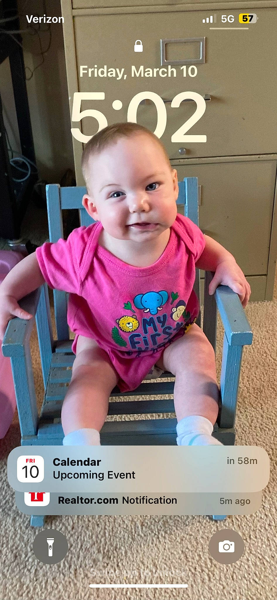 Traci is registered to the contest to win money with this photo: baby, baby_toddler_clothing, cheek, child, eyelash, fun, happy, joy, magenta, person, photo_caption, pink, room, sitting, skin, sleeve, smile, t_shirt, toddler