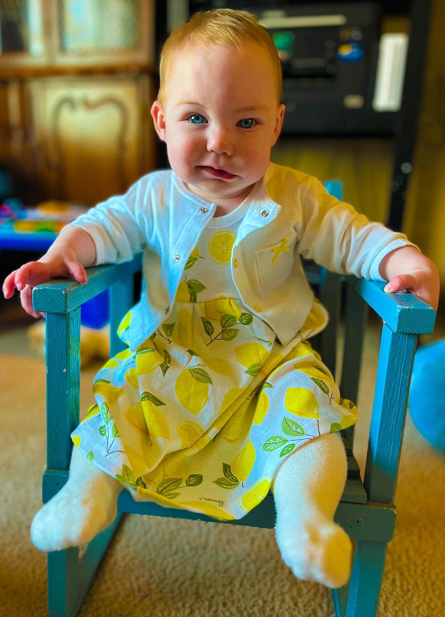 Traci is registered to the contest to win money with this photo: baby, baby_playing_with_toys, baby_toddler_clothing, cheek, child, electric_blue, facial_expression, flooring, fun, happy, head, person, play, product, sitting, skin, sleeve, smile, t_shirt, toddler