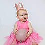 Grace is registered to the contest to win money with this photo: baby, child, birthday, pink_dress, balloon, crown, celebration, happy, smile, sitting, cute, infant, one_year_old, studio, portrait, tutu, barefoot, party, festive, girl