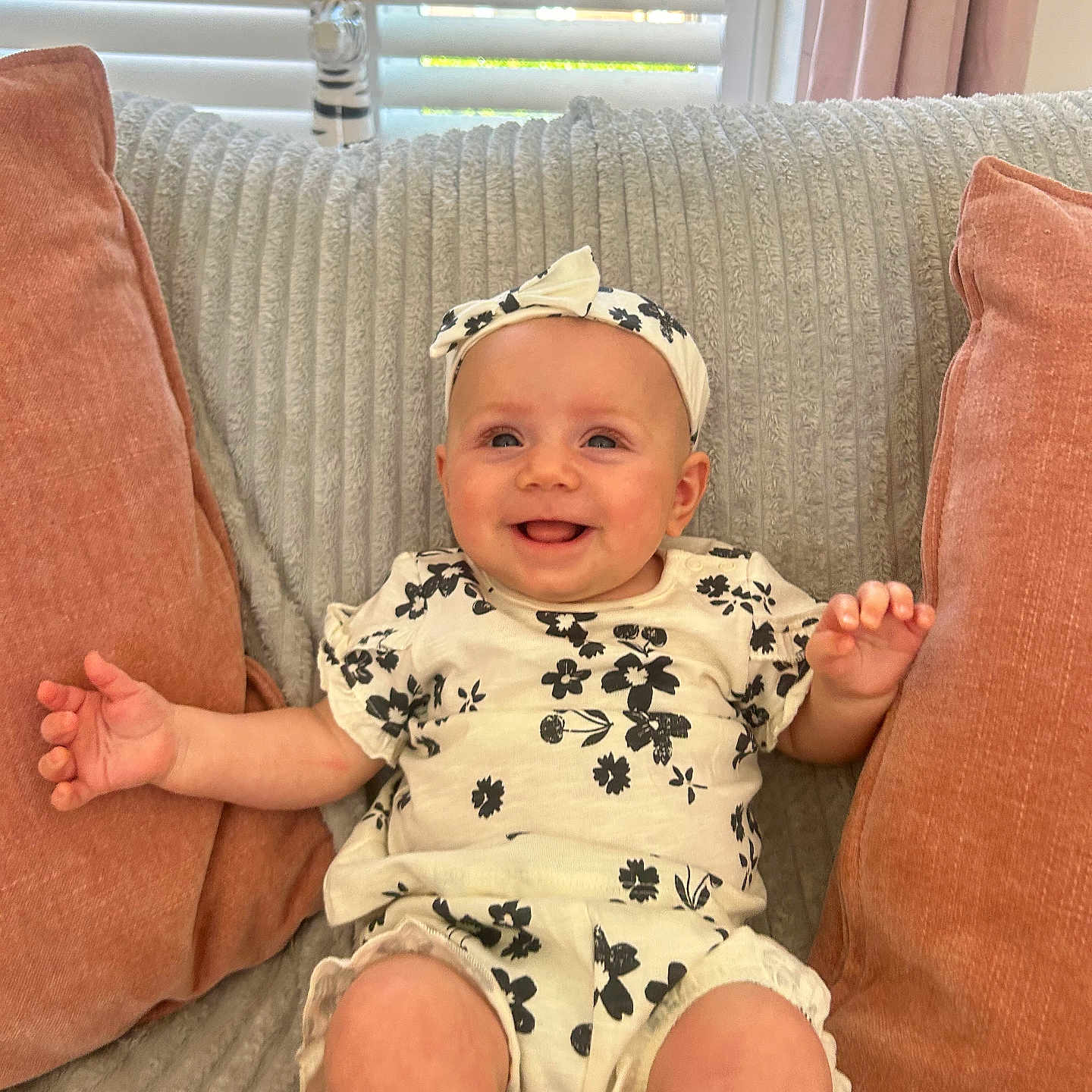 Lilly-Ann is registered to the contest to win money with this photo: baby, blinds, child, comfortable, couch, cozy, crown, cute, decor, floral_outfit, happy, headband, indoors, infant, person, pillows, seated, smiling, window, zebra_figurine