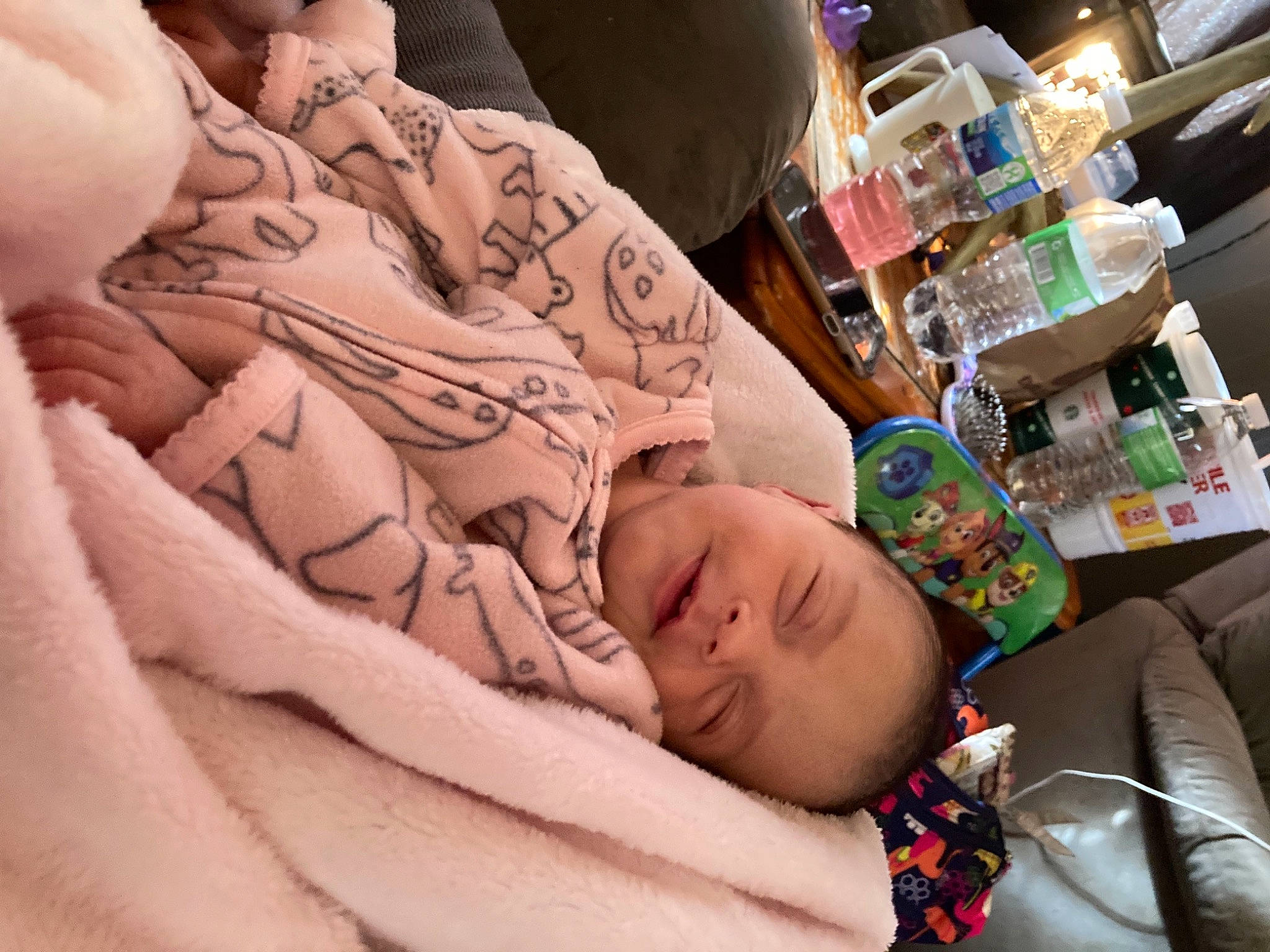 Raylynn is registered to the contest to win money with this photo: baby, baby_sleeping, bedding, bedtime, blanket, bottle, cheek, comfort, couch, linens, living_room, nap, peach, person, sleep, sofa_bed, studio_couch