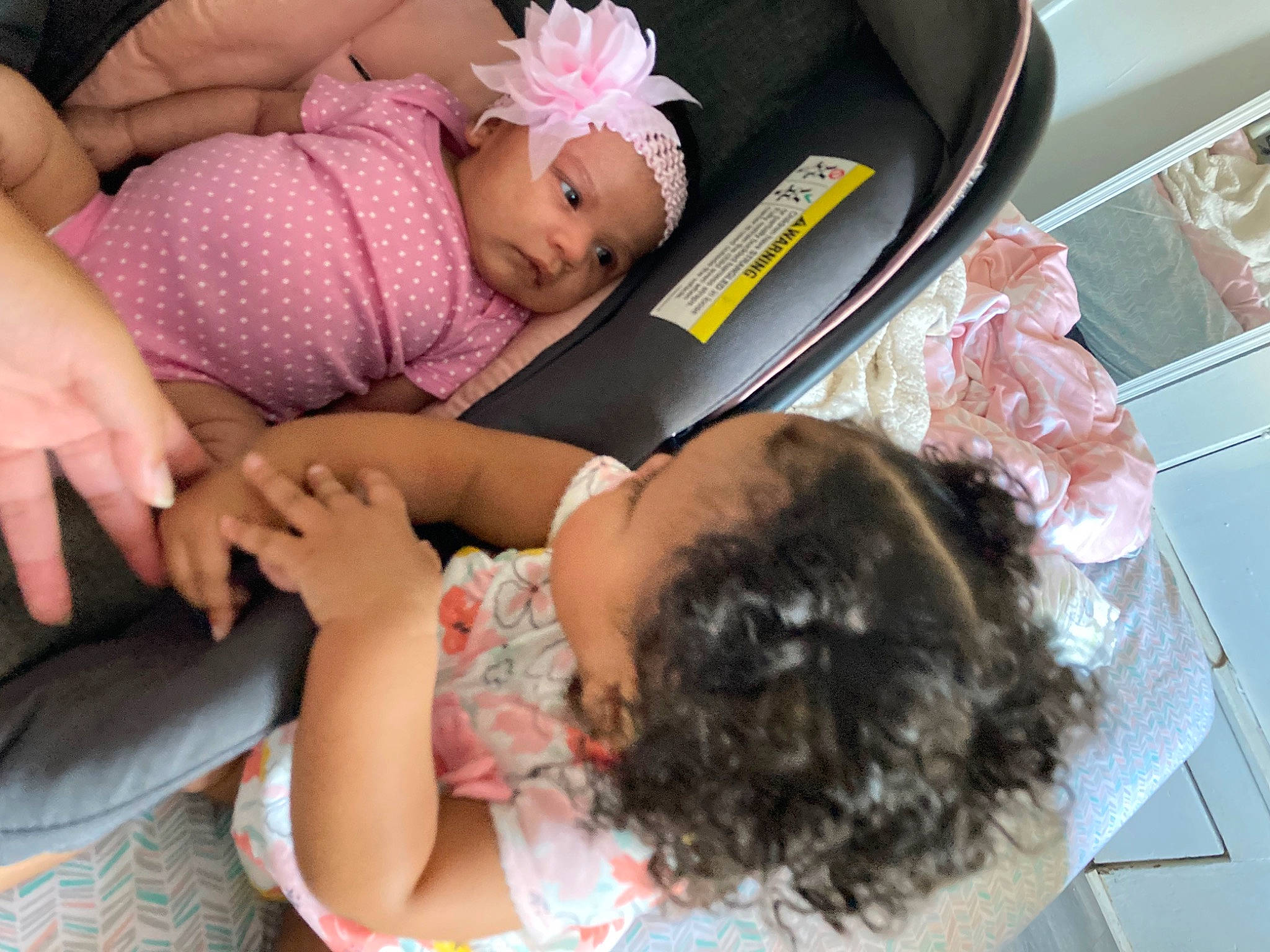 Everly is registered to the contest to win money with this photo: arm, baby, baby_toddler_clothing, child, comfort, event, fashion_accessory, fun, hair_accessory, hand, happy, headband, headpiece, headwear, human, nail, person, pink, sitting, skin