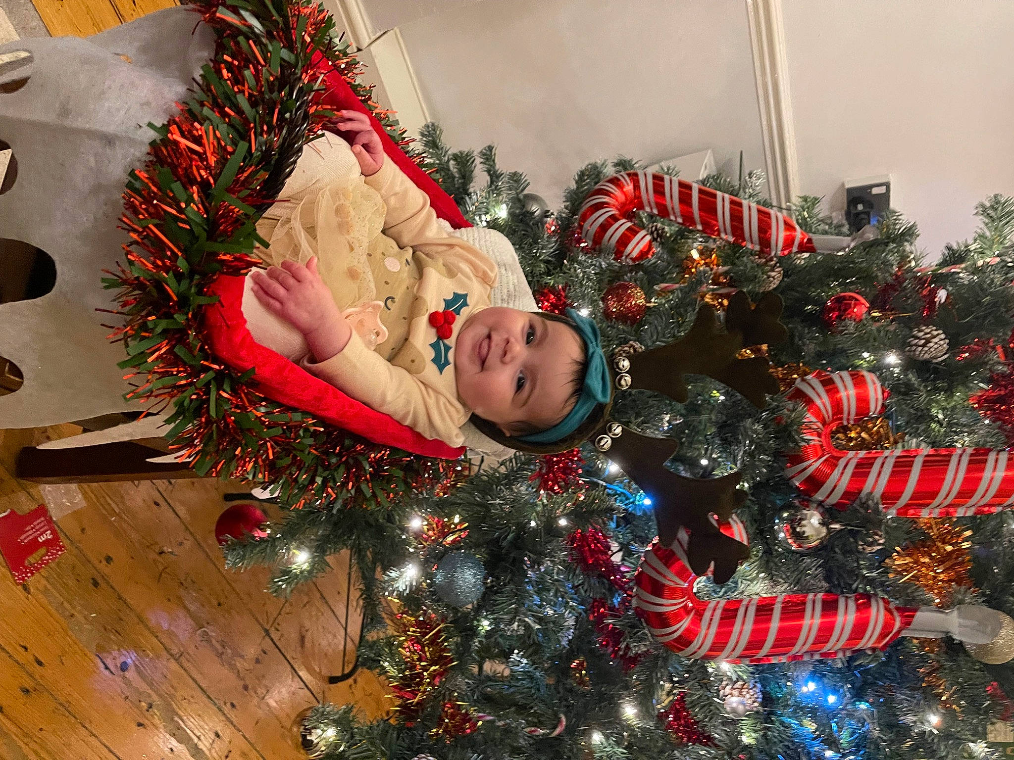 Clara joined the competition — help win amazing prizes! christmas, christmas_decoration, christmas_eve, christmas_ornament, christmas_tree, conifer, event, evergreen, happy, head, headwear, holiday, holiday_ornament, human_body, joy, ornament, person, plant, smile, toddler
