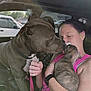 Furlow is registered to the contest to win money with this photo: affection, bonding, car_interior, closeup, collar, daylight, dog, holding, human, interaction, leash, love, mammal, pet, pink_clothing, puppy, seat, vehicle, window, woman