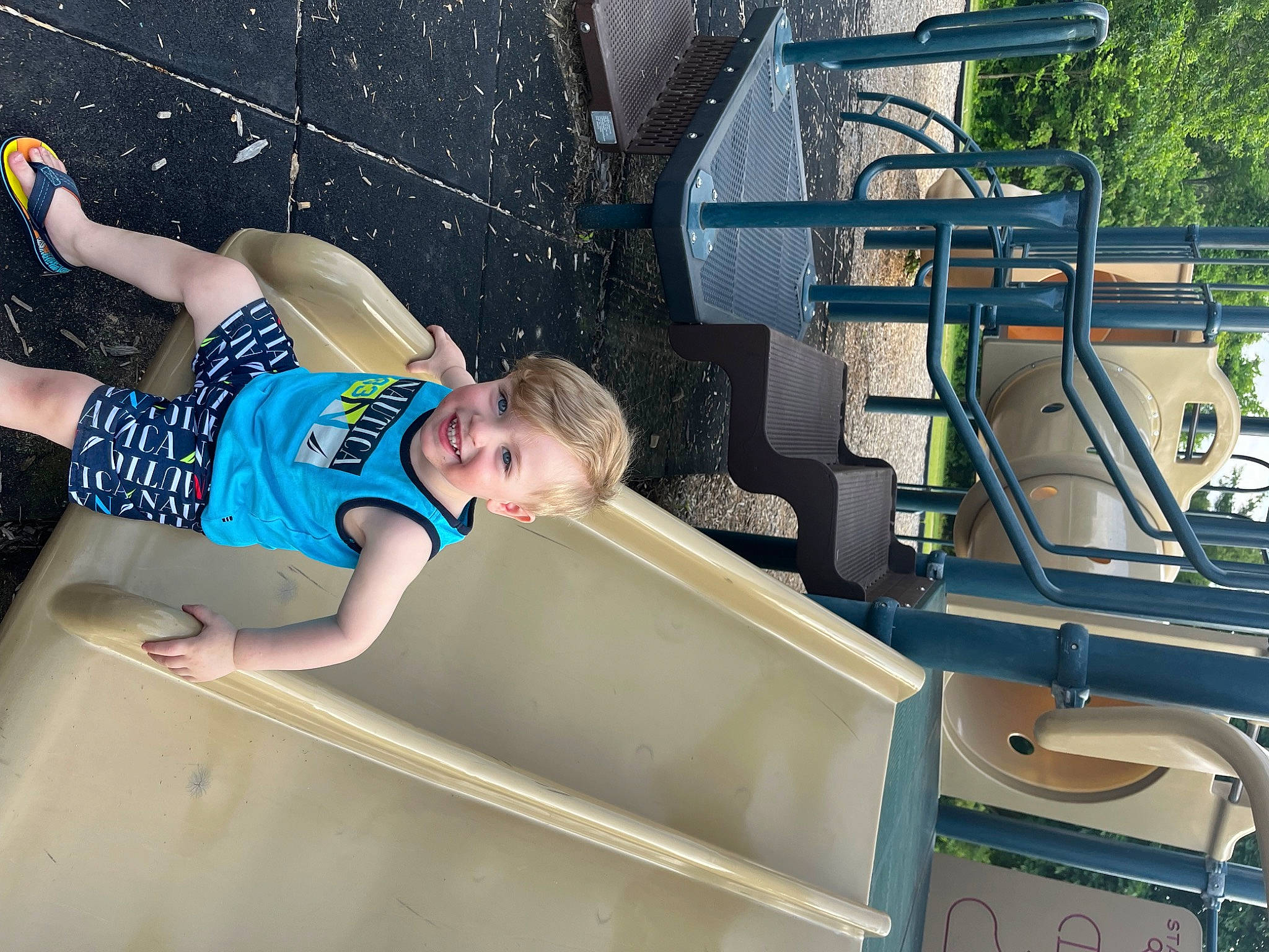 Parker is registered to the contest to win money with this photo: automotive_exterior, electric_blue, engineering, fun, human_leg, joy, leisure, machine, motor_vehicle, naval_architecture, person, recreation, shorts, t_shirt, toddler, transport, tree, vacation