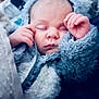 Livia participe au concours pour gagner de l'argent avec cette photo : baby, sleeping, face, hands, blue_jacket, cozy, fluffy, infant, closeup, soft_texture, peaceful, child, portrait, warmth, cute, young, zipped_jacket, resting, tender, comfort