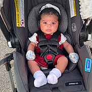 Zyrah is registered to the contest to win money with this photo: baby, stroller, infant, car_seat, seatbelt, mittens, socks, headband, outdoor, curious, child, person, clothing, transportation, safety, baby_carrier, young_child, cute, toddler, infant_seat