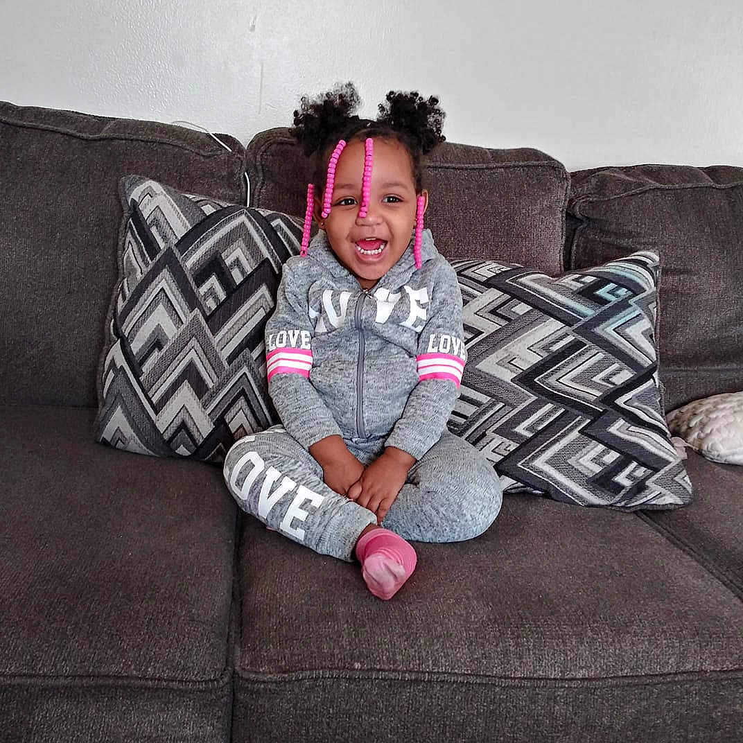 Imani is registered to the contest to win money with this photo: cool, design, fun, furniture, girl, joy, pattern, person, photograph, photography, product, sitting, textile