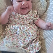 Alaina joined the competition — help win amazing prizes! baby, child, smiling, headband, bow, dress, floral_pattern, cushion, polka_dot, sock, denim, seated, happy, infant, indoors, cute, person, apparel, fabric, young_child