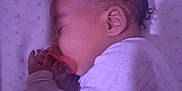 Nadaijah is registered to the contest to win money with this photo: baby, sleeping, pacifier, pajamas, blanket, infant, child, face, hand, ear, cozy, rest, peaceful, indoors, portrait, closeup, soft_lighting, cute, sleep, newborn