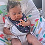 Nadaijah joined the competition — help win amazing prizes! baby, child, infant, baby_seat, bib, colorful, patterned, hair, cute, chubby, clothing, indoor, seated, straps, person, face, expression, hand, legs, comfort