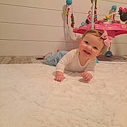 Bryar joined the competition — help win amazing prizes! baby, child, infant, smiling, pink_bow, white_rug, floor, wooden_floor, toy, baby_toy, activity_center, indoor, person, cute, happy, crawling, headband, clothing, play, young_child
