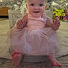 Bryar joined the competition — help win amazing prizes! baby, child, pink_dress, bow, smile, christmas_tree, holiday_lights, ornaments, pine_cones, carpet, floor, indoors, festive, cute, happy, sitting, decorations, infant, holiday, celebration
