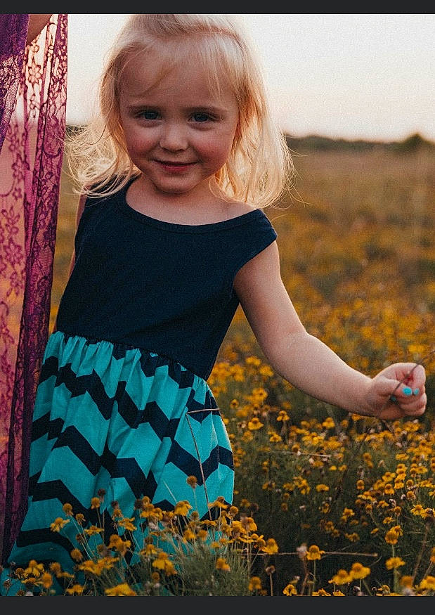 Scarlett is registered to the contest to win money with this photo: adaptation, blond, child, dress, fun, grass, happy, joy, leaf, pattern, person, photography, plant, play, smile, spring, t_shirt, toddler, tree, wildflower