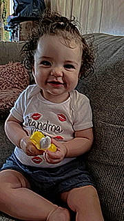 Bayleigh is registered to the contest to win money with this photo: baby, baby_toddler_clothing, blond, cheek, eye, face, food, fun, hair, happy, head, iris, joy, mouth, nose, person, sitting, skin, sleeve, smile