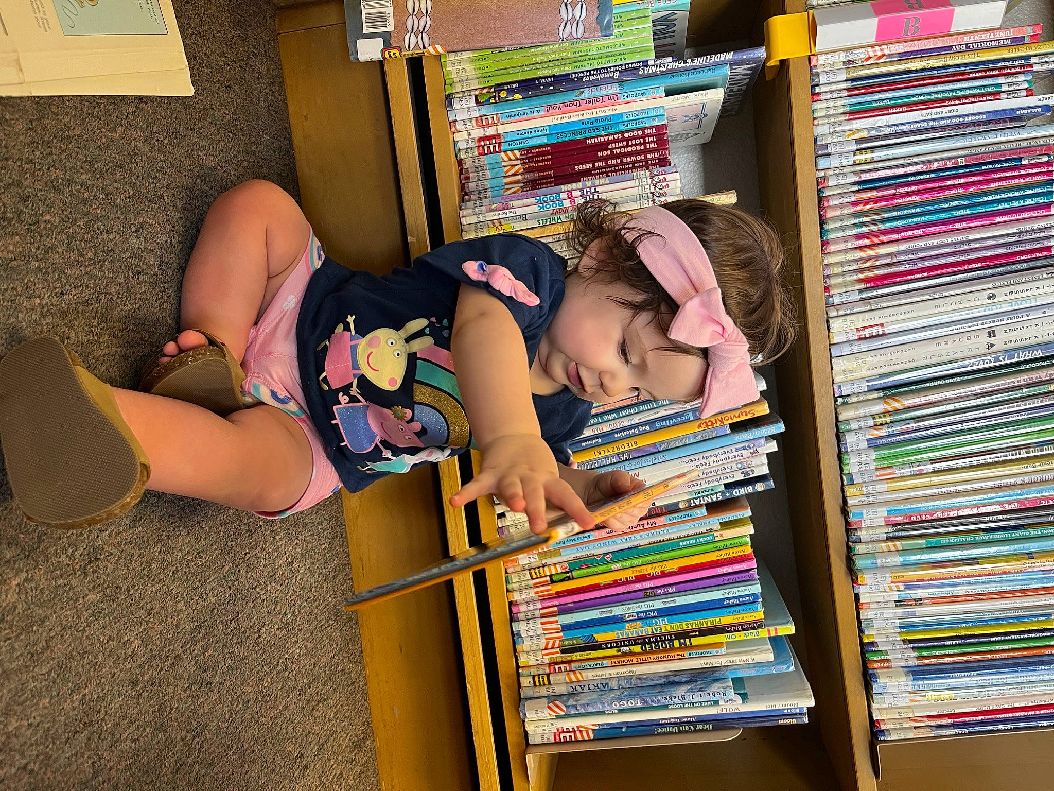 Bayleigh is registered to the contest to win money with this photo: beauty, book, bookcase, child, fashion, foot, fun, headwear, human_leg, knee, leg, leisure, pattern, person, product, publication, retail, room, shelf, shelving