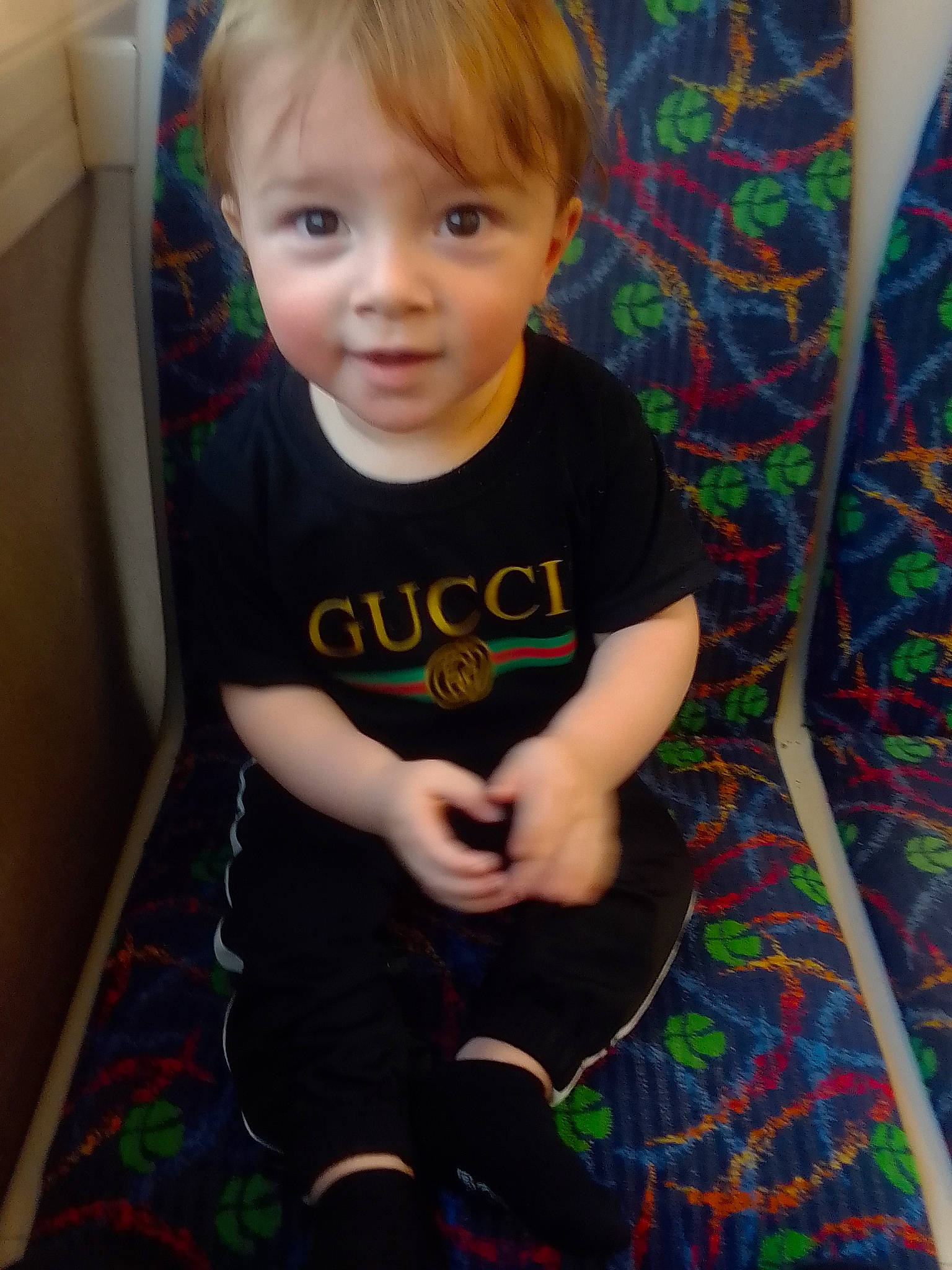 Kanan joined the competition — help win amazing prizes! baby, baby_toddler_clothing, cheek, child, eye, face, flooring, fun, head, human_leg, lap, pattern, person, room, sitting, sleeve, smile, sock, t_shirt, thigh