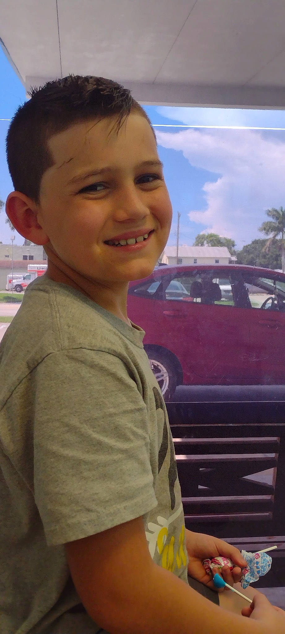 Aiden joined the competition — help win amazing prizes! automotive_design, automotive_exterior, automotive_lighting, automotive_tire, car, chin, cool, eye, happy, hood, joy, mode_of_transport, motor_vehicle, person, sky, smile, standing, tire, travel, vehicle