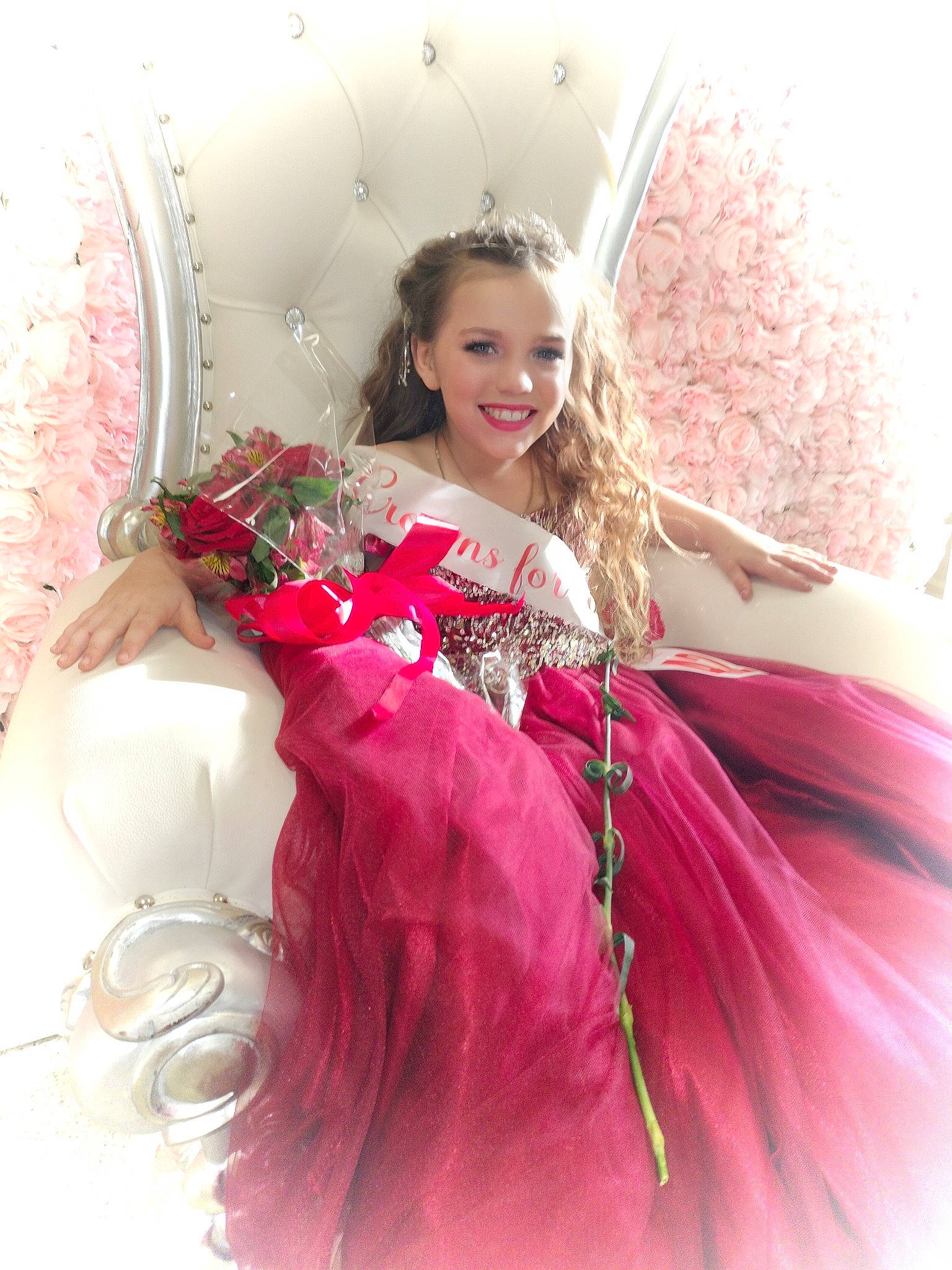 Ashlee joined the competition — help win amazing prizes! arm, bridal_accessory, bridal_clothing, dress, embellishment, face, fashion_design, flower, formal_wear, gown, hair, happy, head, headpiece, joy, magenta, person, petal, pink, smile