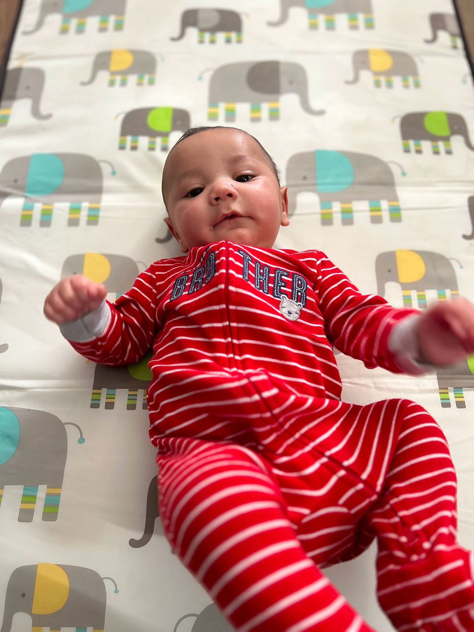 Wyatt is registered to the contest to win money with this photo: baby, baby_toddler_clothing, cheek, child, comfort, facial_expression, flooring, fun, green, happy, human, magenta, pattern, person, play, room, sitting, skin, sleeve, toddler