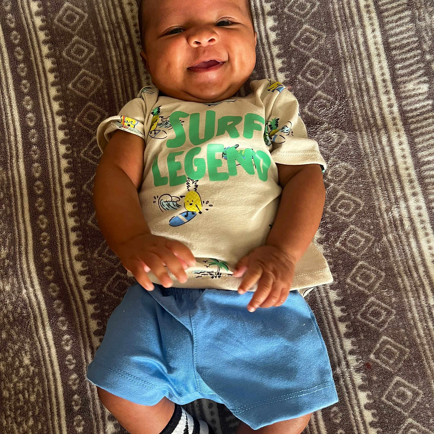 Adonis joined the competition — help win amazing prizes! baby, baby_clothes, blanket, casual, child, clothing, cute, happy, indoors, infant, lying_down, pattern, person, portrait, shorts, skin, smiling, socks, tshirt, young_child