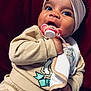 baby, pacifier, headband, bow, clothing, beige, hand, face, child, cute, infant, portrait, indoors, toddler, expression, soft, fabric, warm, cozy, background