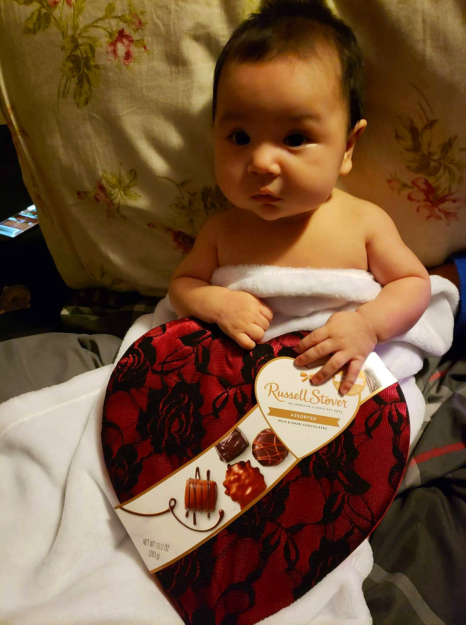 Bailey is registered to the contest to win money with this photo: abdomen, baby, baby_products, baby_sleeping, baby_toddler_clothing, chest, child, comfort, comfort_food, flesh, hairstyle, hand, happy, junk_food, linens, mouth, pattern, person, sitting, sweetness