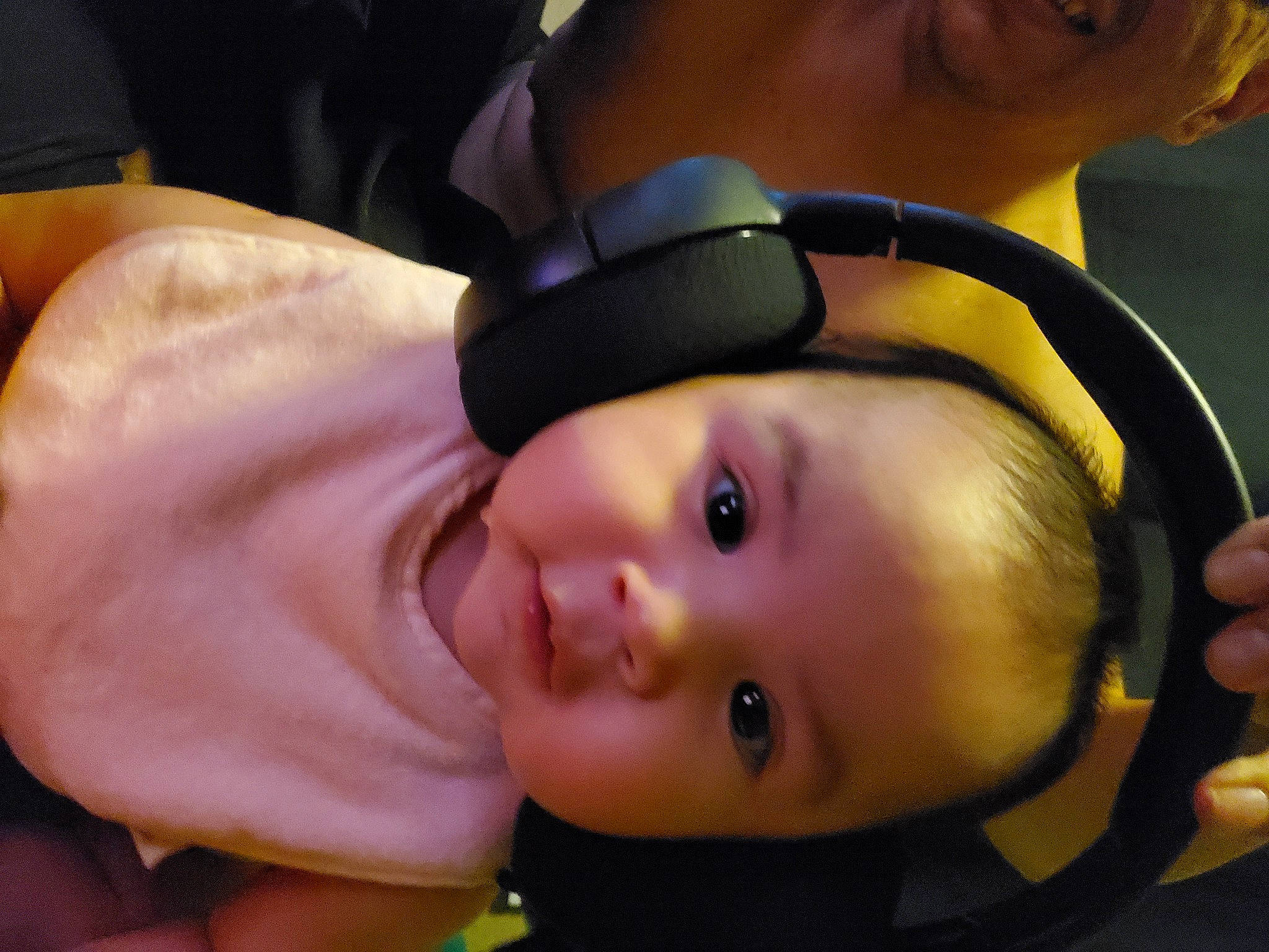 Bailey is registered to the contest to win money with this photo: audio_equipment, baby, baby_toddler_clothing, cheek, cool, ear, eyebrow, eyelash, face, finger, forehead, gesture, headgear, hearing, mouth, neck, nose, person, skin, toddler