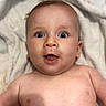 baby, blanket, chest, child, closeup, cute, expression, eyes, face, head, human, indoors, infant, lying_down, mouth, newborn, person, portrait, skin, soft