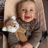 Mahé a rejoint le concours — aidez-le/la à gagner de superbes lots ! baby, baby_chair, blue_eyes, brown_clothing, child, closeup, cozy, cute, hands, happy, indoor, infant, person, plush_toy, portrait, quilted, seated, smiling, soft_lighting, stuffed_animal