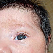 Delilah is registered to the contest to win money with this photo: baby, infant, child, face, close_up, portrait, blue_eye, eye, hair, cheek, nose, mouth, skin, sleepy, curious, indoor, blanket, textured_fabric, flash_photography, head
