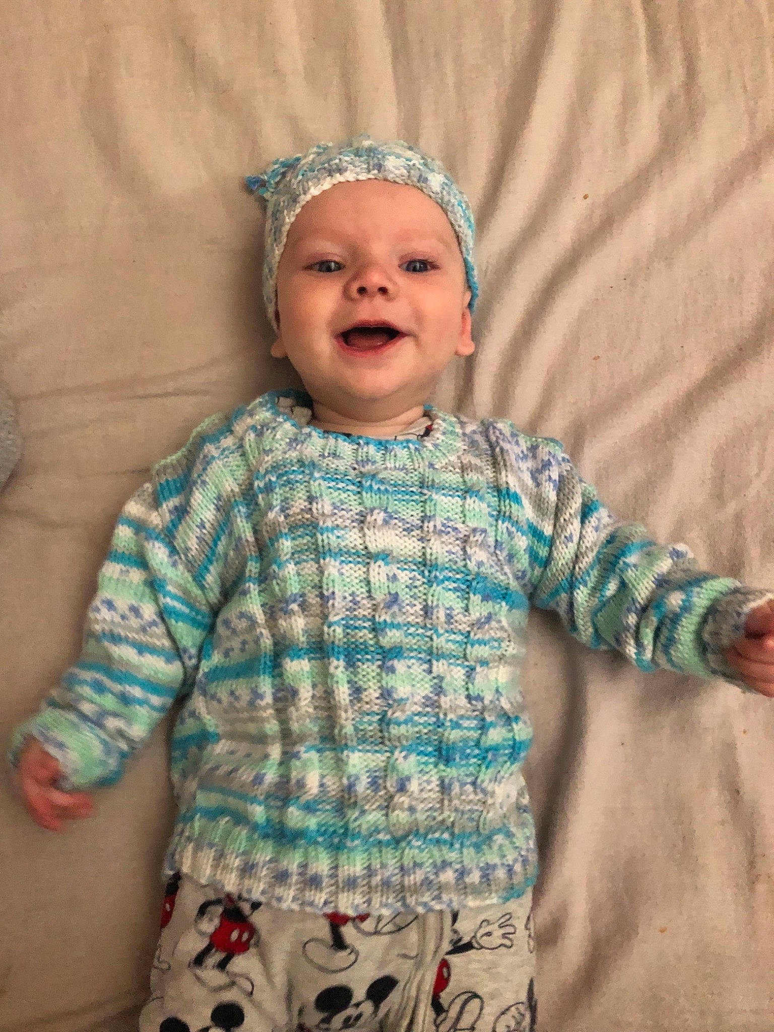 Elijah joined the competition — help win amazing prizes! baby, baby_toddler_clothing, child, fashion_accessory, hair_accessory, head, headgear, knitting, pattern, person, sleeve, smile, textile, toddler, turquoise