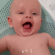 Kobi is registered to the contest to win money with this photo: baby, bath, water, bubbles, smile, happy, child, skin, head, face, mouth, tongue, ear, bathtub, splash, cute, infant, playful, wet, body