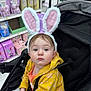 Mckenna is registered to the contest to win money with this photo: toddler, child, bunny_ears, stroller, yellow_jacket, pink, store, shopping, shelf, products, face, portrait, clothing, baby, cute, indoors, retail, grocery, expression, seated