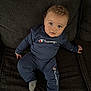 Calais joined the competition — help win amazing prizes! baby, blue_outfit, casual, champion_brand, child, clothing, comfortable, couch, cozy, curly_hair, cute, face, indoor, infant, looking_up, portrait, seated, socks, soft_texture, young_child