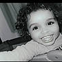 Kaïss participe au concours pour gagner de l'argent avec cette photo : baby, child, smiling, curly_hair, face, teeth, indoor, long_sleeve_shirt, happy, person, cute, portrait, toddler, closeup, expression, young_child, childhood, joy, innocence, black_and_white