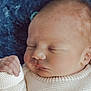 newborn, baby, sleeping, close_up, face, hand, sweater, knit, blanket, cozy, infant, cheek, eyelid, nose, ear, skin, portrait, newborn_hand, peaceful, soft_texture