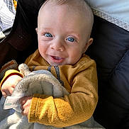 Otto joined the competition — help win amazing prizes! baby, child, smiling, blue_eyes, sweater, blanket, cozy, happy, infant, cute, portrait, indoors, soft_light, hand, face, person, clothing, warm_colors, texture, comfort