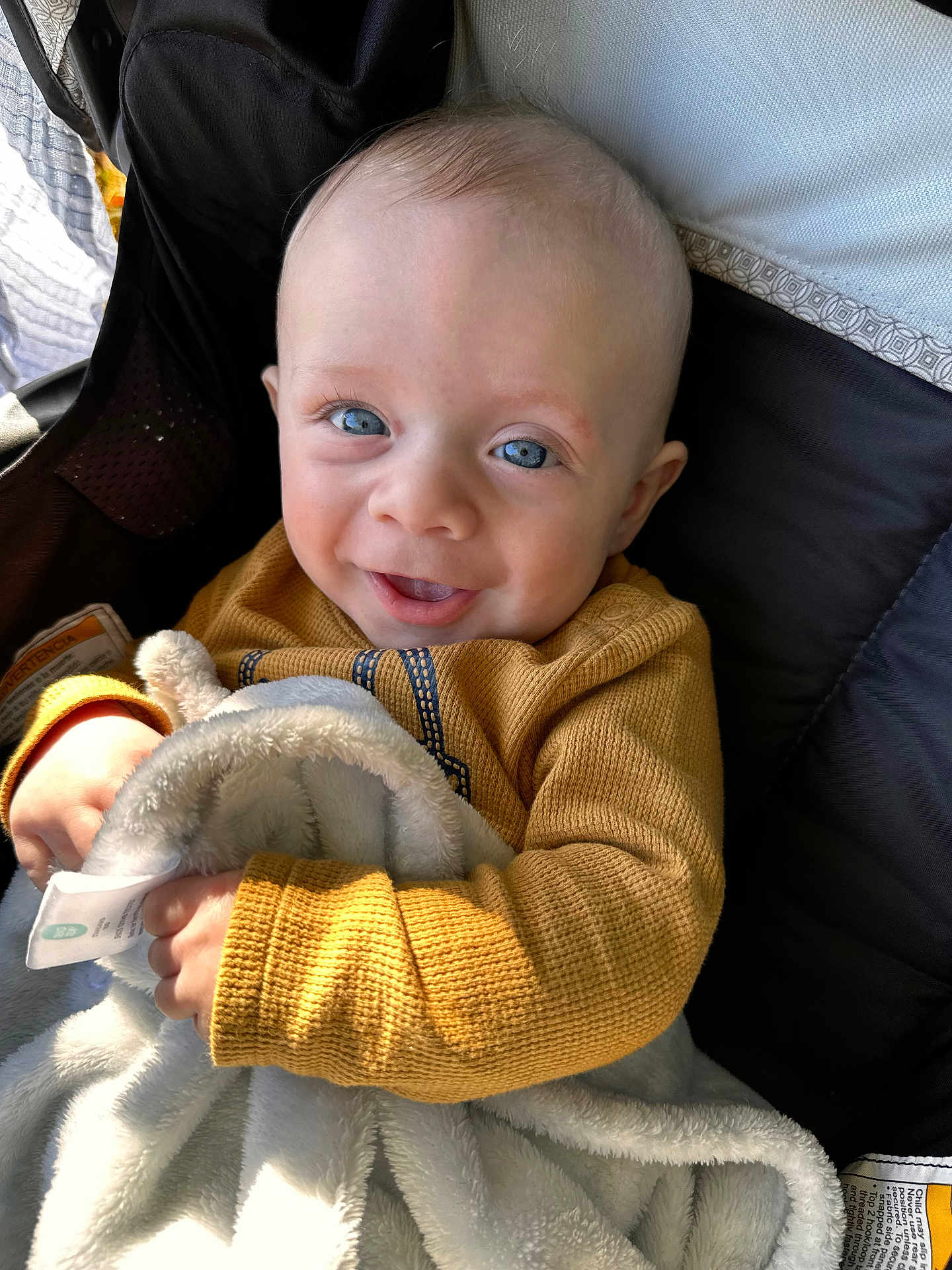 Otto joined the competition — help win amazing prizes! baby, child, smiling, blue_eyes, sweater, blanket, cozy, happy, infant, cute, portrait, indoors, soft_light, hand, face, person, clothing, warm_colors, texture, comfort