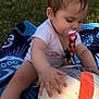 Jade participe au concours pour gagner de l'argent avec cette photo : baby, blanket, casual_clothing, child, closeup, curious, daylight, fun, grass, nature, outdoor, pacifier, person, playing, recreation, sitting, soccer_ball, summer, toy, wet_hair